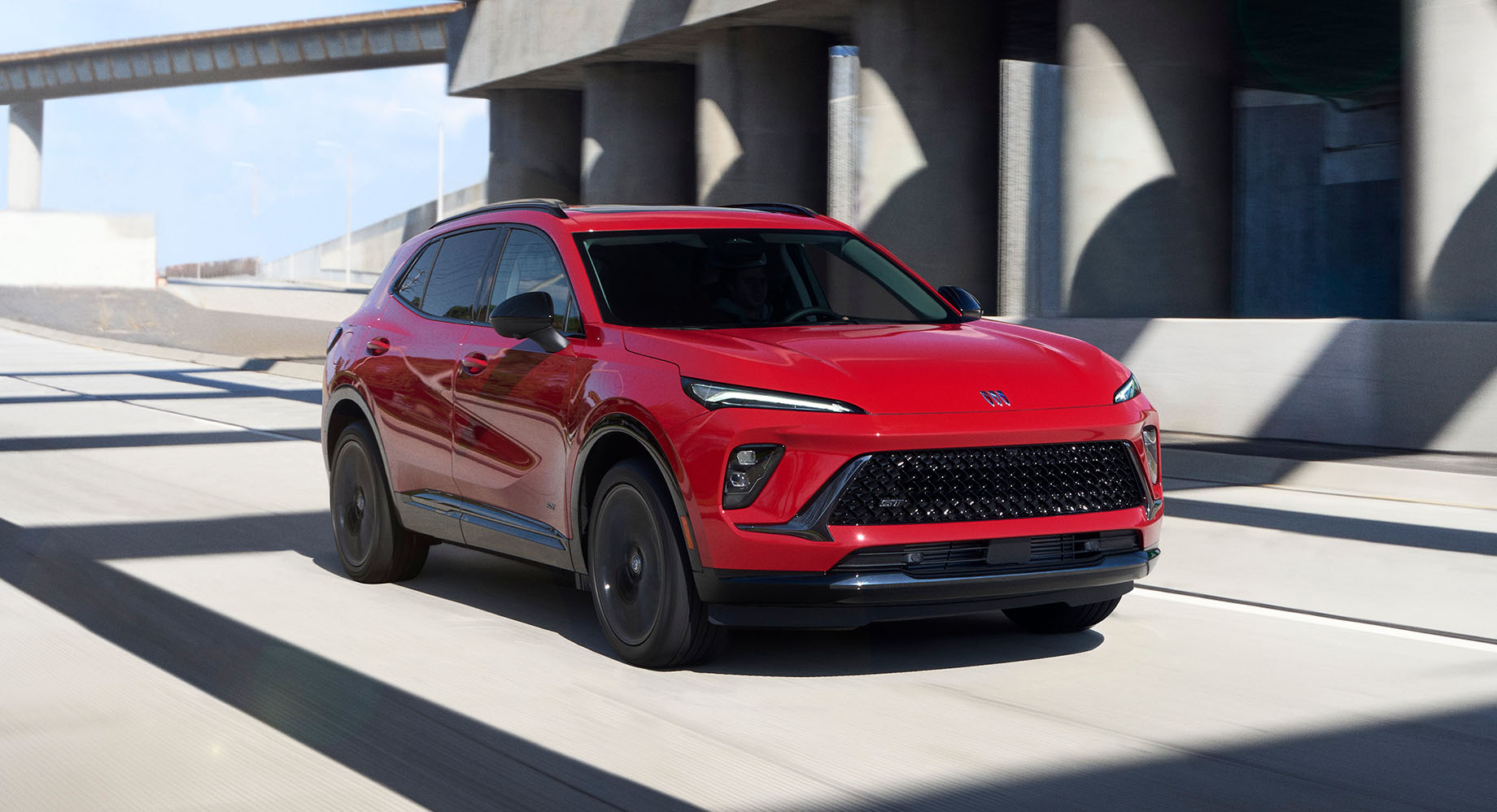 Blue Buick Envision parked in front of a building