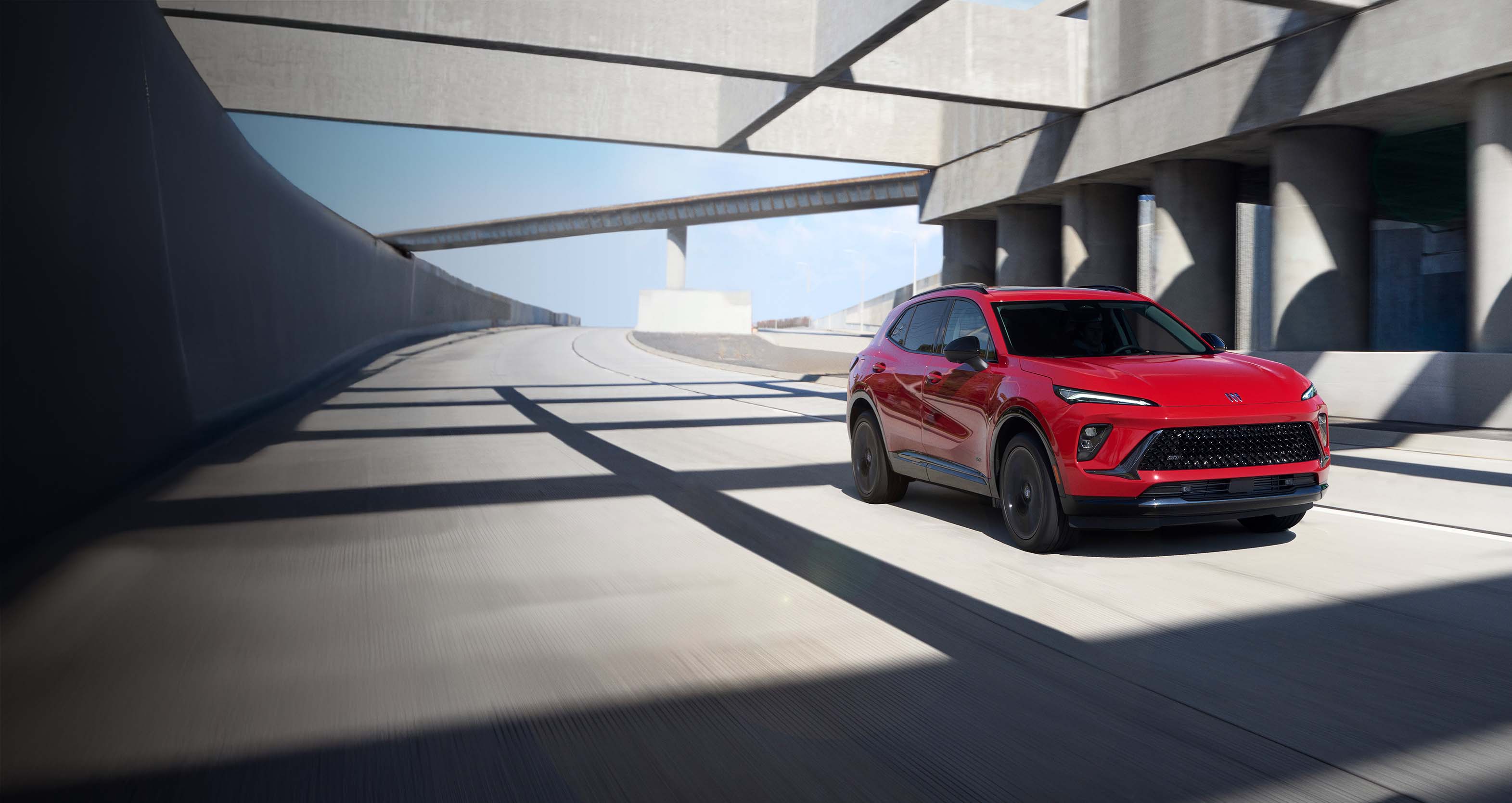 White Buick Envision is driving through a tunnel