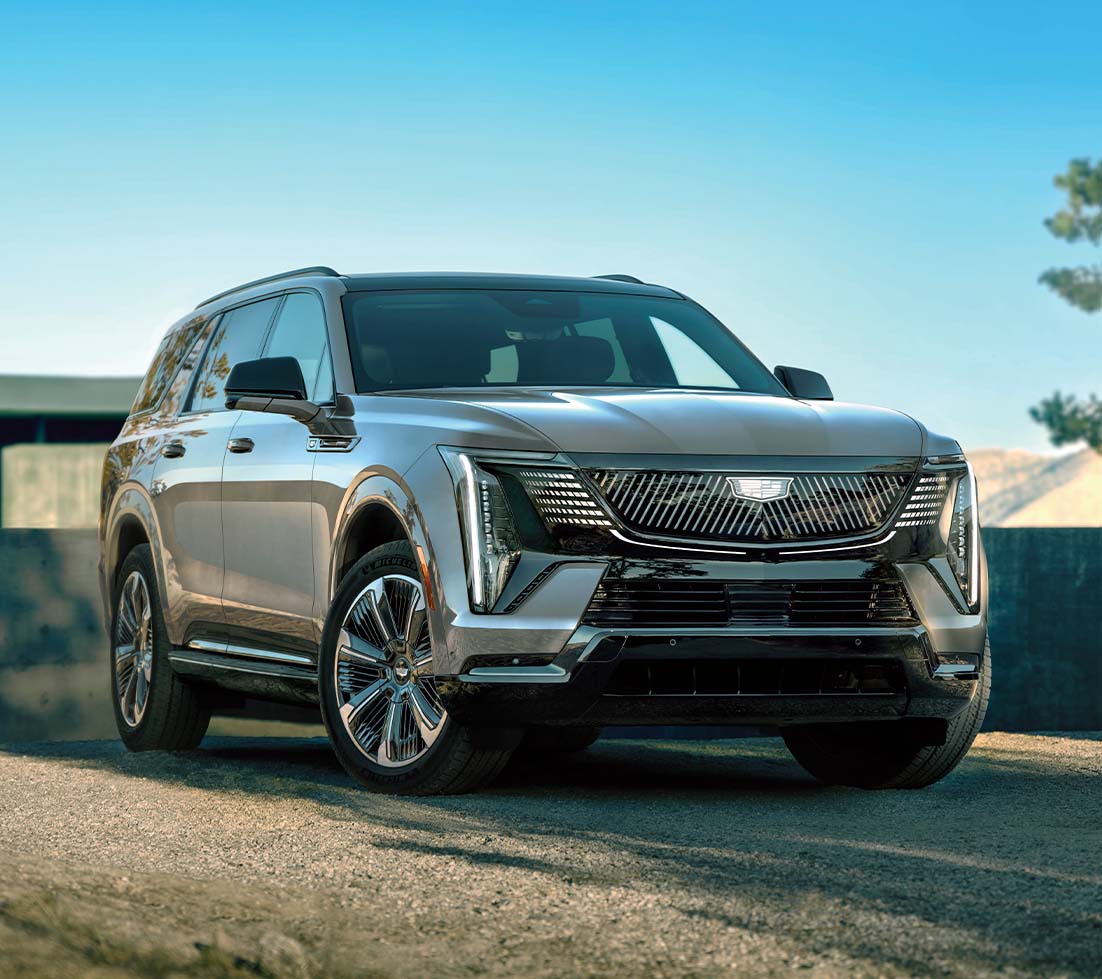 Grey Cadillac Escalade IQL parked on a gravel road