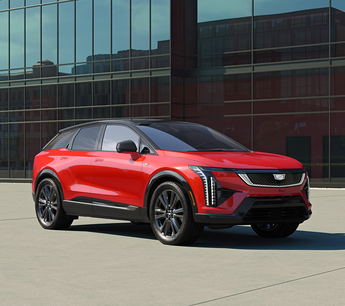 Red Cadillac OPTIQ parked in front of a building