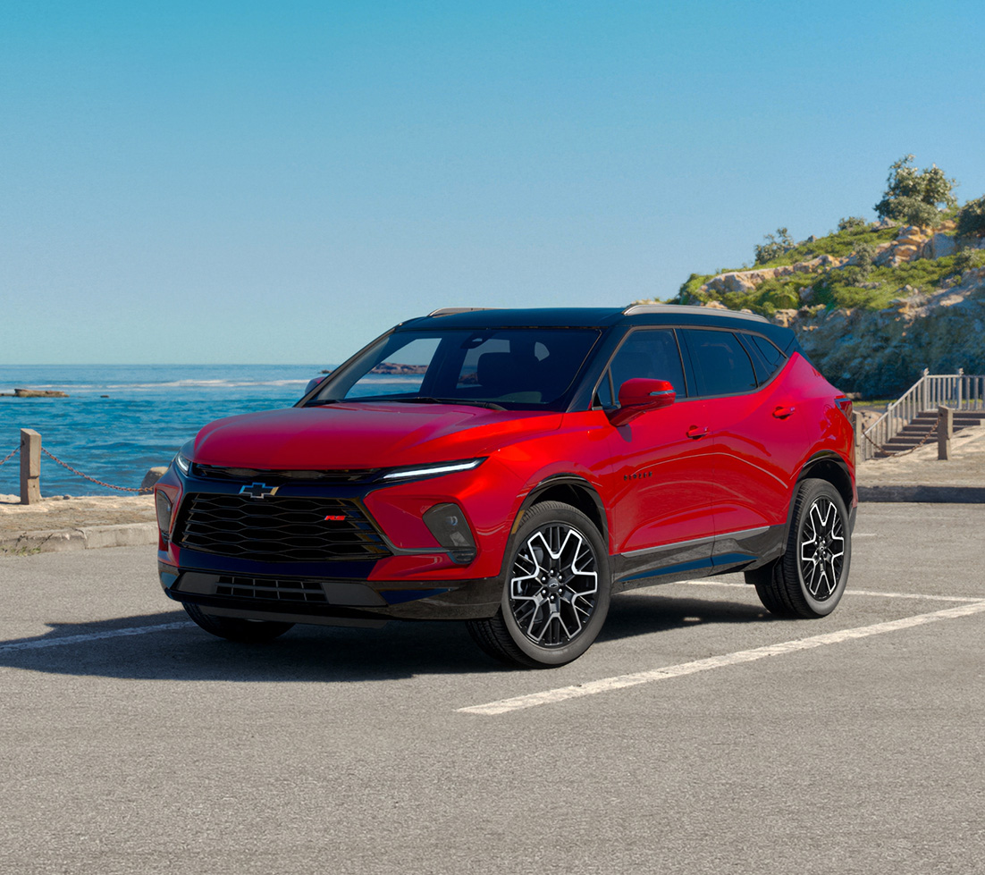 Grey Chevrolet Blazer EV is driving down a city street