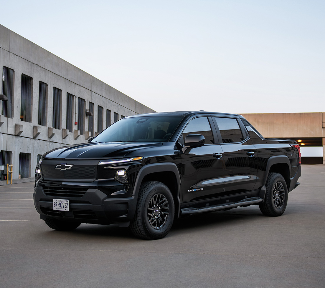 Black Silverado EV is parked in front of a building