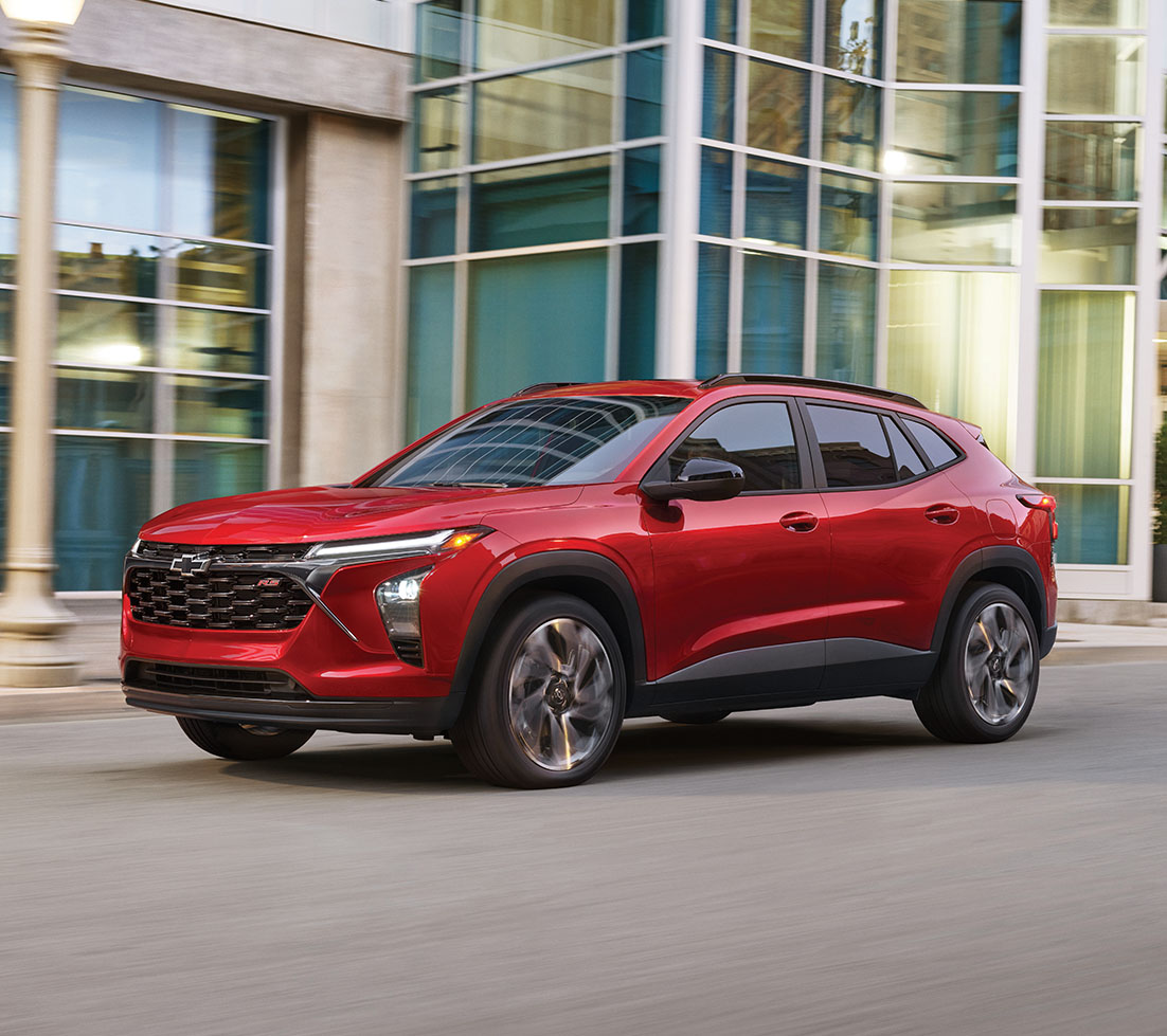 A sleek red Chevrolet Trax on a modern city street