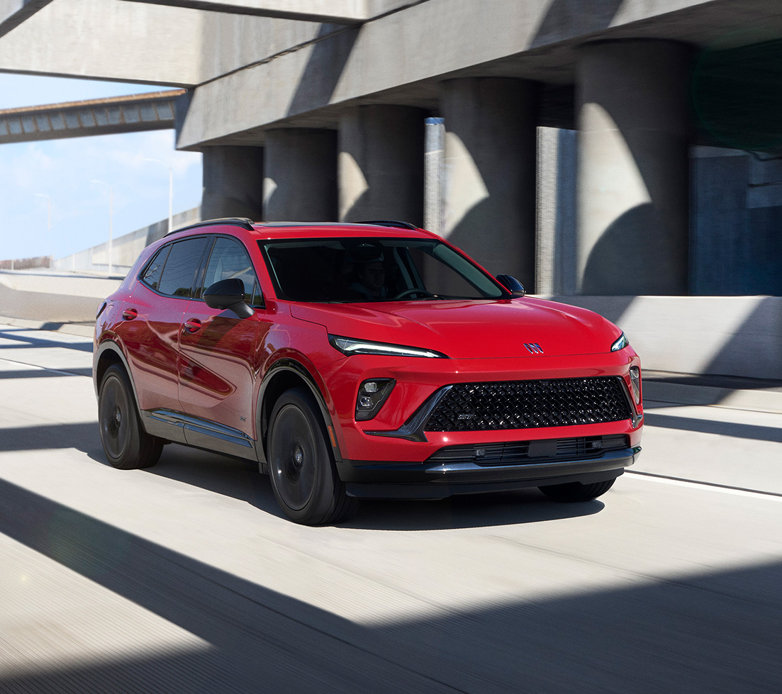 Blue Buick Envision parked in front of a building